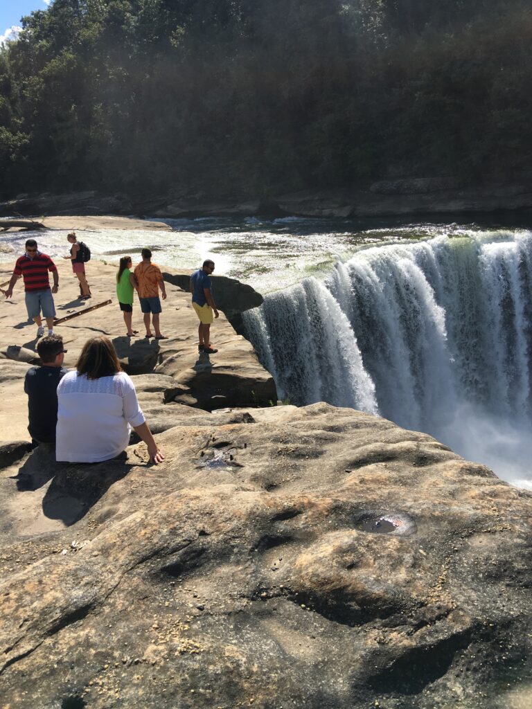 people on the edge of Cumberland Falls
